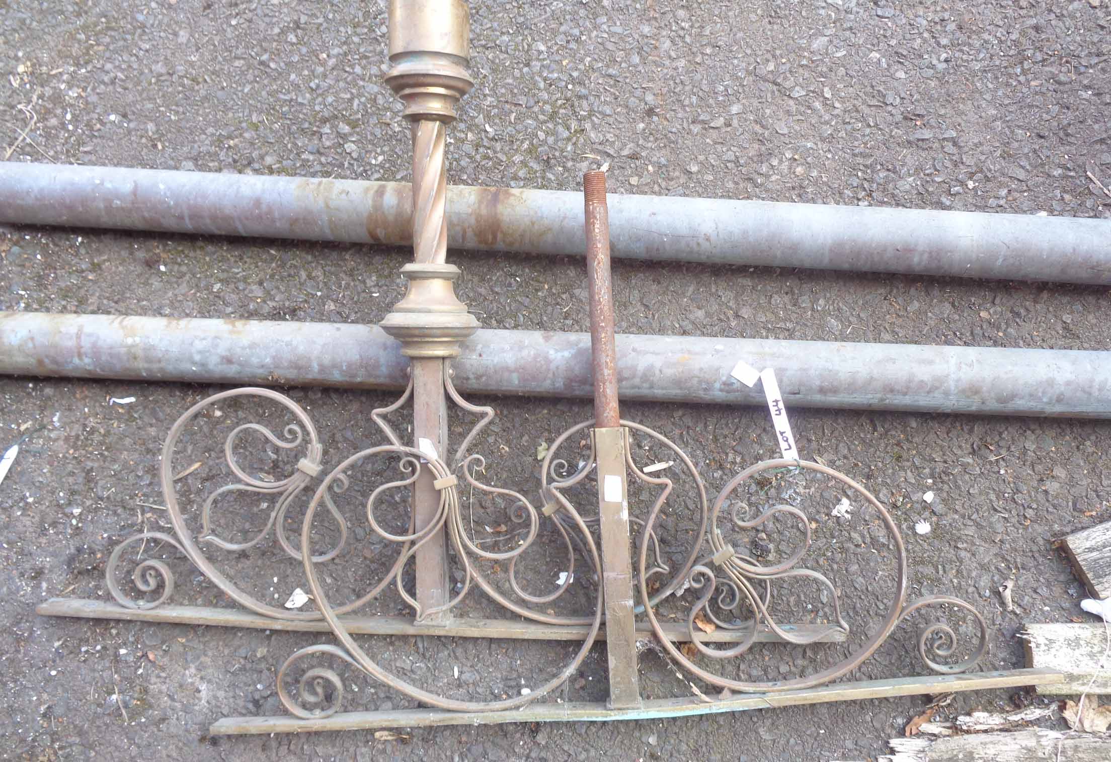 A large brass rod screen hanging pole with decorative finials