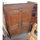 A 4' 9 1/2" antique French oak double armoire with shelves and drawers enclosed by a pair of