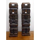 A pair of 22 3/4" Bolivian carved hardwood indigenous figural stands with detachable lids