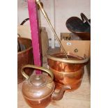 A copper coal scuttle, copper kettle, and assorted brass fire irons