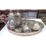A silver plated oval gallery tray, coffee set, toast rack, and muffin dish