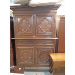 A 5' 5" 19th Century French oak two part cabinet with dentil cornice and pair of panelled cupboard