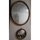A 20th Century gilt framed oval wall mirror - sold with a small gilt framed convex wall mirror