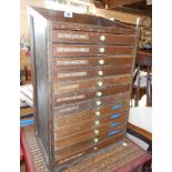 A 14 1/4" vintage stained mixed wood typesetter's chest with flight of twelve partioned drawers