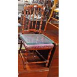 A late Victorian stained wood framed spindle back bedroom chair with remains of upholstery