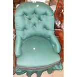 A Victorian nursing chair with later button back upholstery, set on turned front legs with porcelain