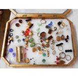 A glass topped display case containing costume and other jewellery lockets, etc.