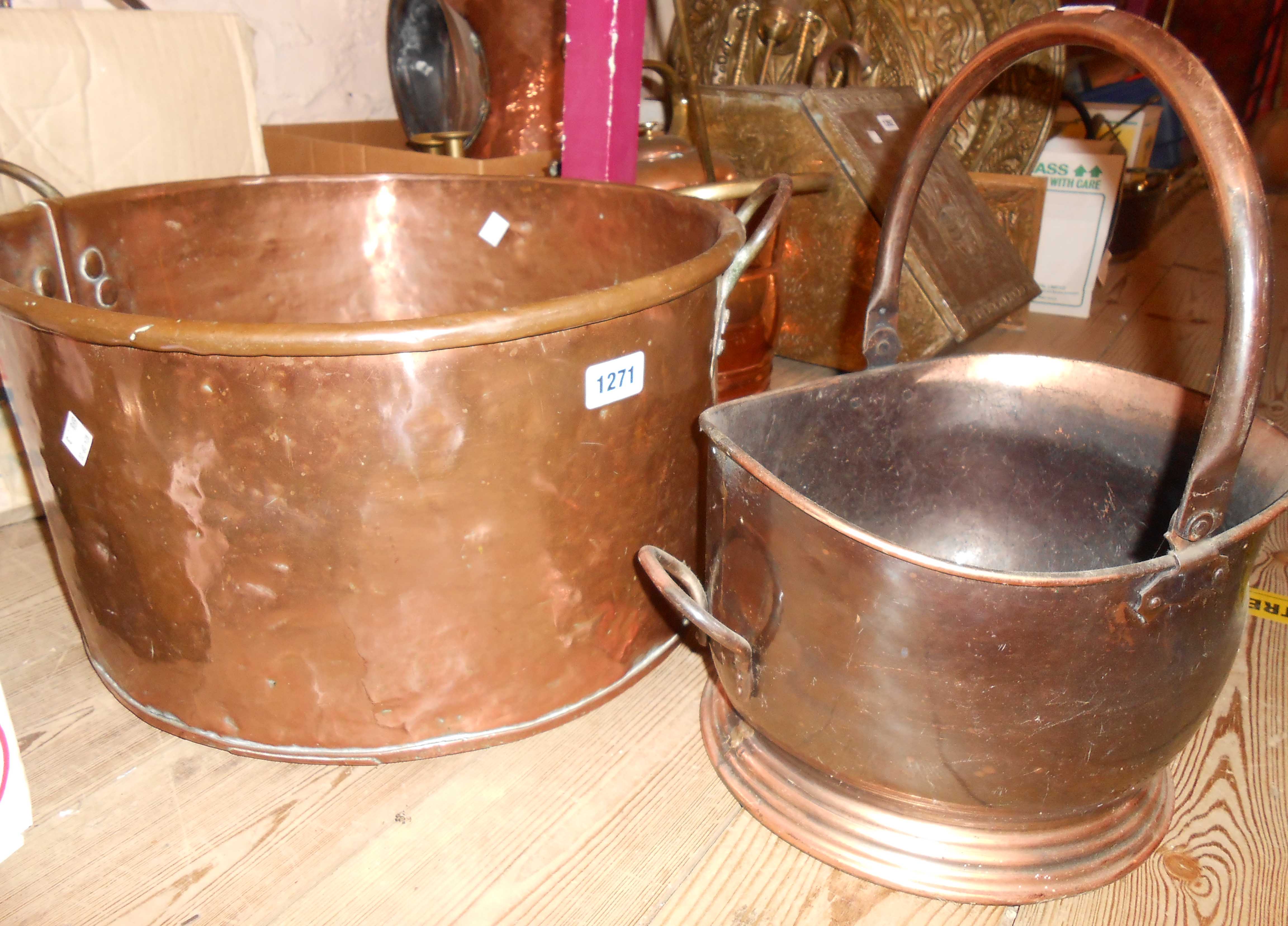 An antique heavy copper pan with iron handles - sold with a coal helmet