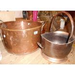 An antique heavy copper pan with iron handles - sold with a coal helmet