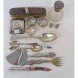 Three silver napkin rings, two thimbles, cigarette case and a damaged silver topped scent bottle -