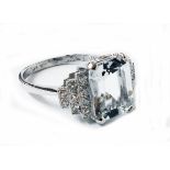 A marked PLAT Art Deco style ring, set with 4ct. emerald cut aquamarine flanked by small diamonds to