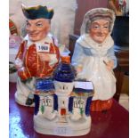 A pair of Staffordshire Punch and Judy Toby jugs - sold with a Staffordshire flatback cottage -