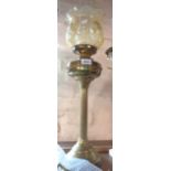 A brass column pattern table oil lamp with amber glass shade