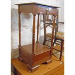 A 15" 20th Century mahogany two tier stand with drawer, turned supports and lift-top compartment