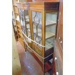 A 4' 1" Edwardian mahogany and strung break bow front display cabinet with moulded raised back,
