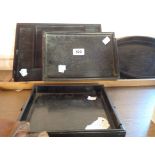 Four ebony and ebonized trays and a Chinese painting