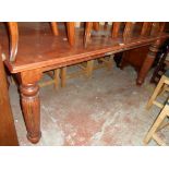 A 6' reproduction mahogany dining table with moulded top, set on heavy turned and reeded legs