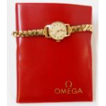 A vintage 9ct. gold cased lady's Omega wristwatch on replacement Montal rolled gold expanding