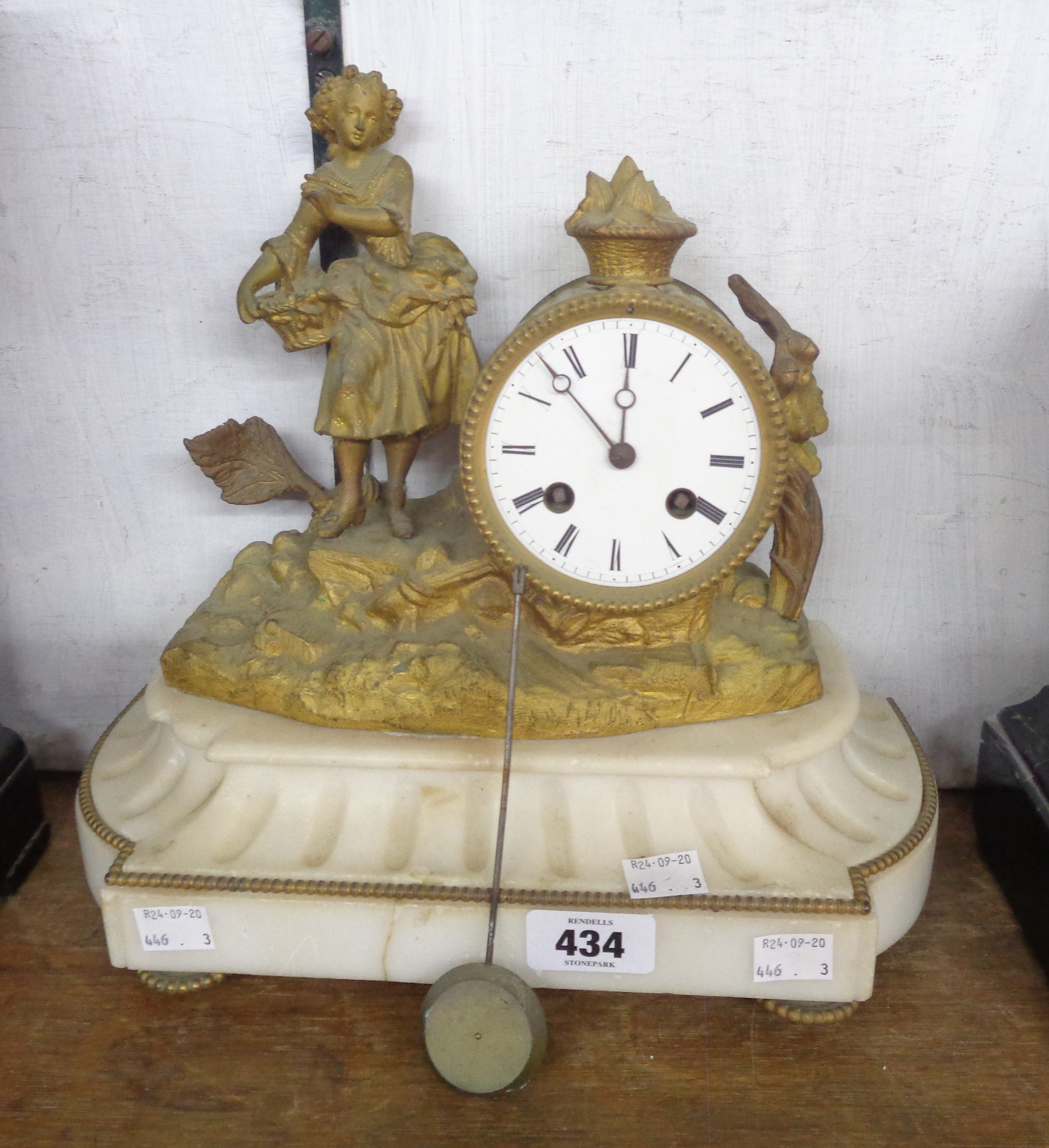 A late 19th Century gilt spelter drum and figural mantle timepiece with shaped white marble base and