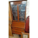 A 31 1/2" early 20th Century bureau/bookcase with pair of beaded glazed panel doors to top, part