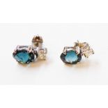 A pair of hallmarked 375 white gold drop ear-rings, each set with oval blue topaz and small