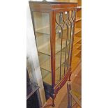 A 30" Edwardian mahogany bow front display cabinet with material lined shelves enclosed by a