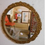 A small vintage gilt framed circular wall mirror