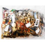 A bag containing a quantity of assorted costume jewellery