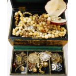 A vintage jewellery box containing costume and other jewellery including silver fobs, yellow metal