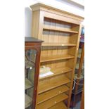 A 3' 3 1/2" waxed pine eight shelf open bookcase, set on plinth base - 7' 2 1/4" high