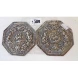 A pair of 4 1/4" Anglo-Indian white metal octagonal plaques with embossed stylised animals to
