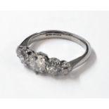 An import marked 750 white gold ring, set with five graduated brilliant cut diamonds