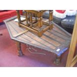 A 4' 5" Eastern iron bound hardwood coffee table of canted lozenge design with strap-work to top and