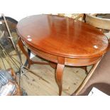 A 3' 6" early 20th Century stained mixed wood oval topped occasional table, set on cabriole supports