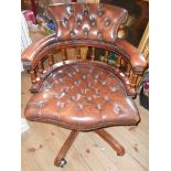 A late 20th Century captain's style swivel office chair with brown button back leather upholstery (