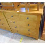 A 35 1/2" polished light oak and mixed wood chest of two short and three long drawers, set on