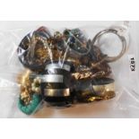 A bag containing a quantity of assorted costume jewellery including numerous bangles, etc.