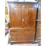 A 4' 1" 19th Century flame mahogany veneered two part linen press with Greek key cornice, the
