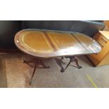 A 3' 11 1/2" 20th Century reproduction mahogany and leather inset twin pedestal coffee table with
