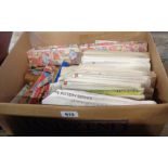 A box containing assorted vintage textiles items including patterns, pinking shears, needles,