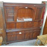 A 6' Stronbow Furniture reproduction mahogany two part wall unit with central arched recess,