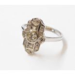 A marked PLAT Art Deco style shaped panel ring, with central collar set round brillant diamond and