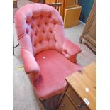 A Victorian drawing room tub elbow chair with old rose velour button back upholstery, set on