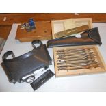 A small assortment of tools including Vernier caliper, miniature vise, spirit level, etc.