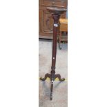 An Edwardian mahogany torchere, set on turned pillar and tripod base