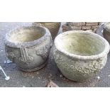 Two concrete garden planters of circular form, one with grapevine decoration, the other with