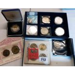 A coin collector's tray containing three US Morgan silver Dollars (two encapsulated), a 1922 Liberty