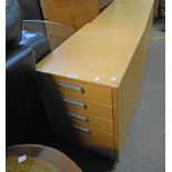 A 17 1/4" modern blonde wood effect graduated four drawer filing cabinet, set on casters