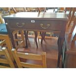 A 29 1/4" old walnut mixed wood lowboy with frieze drawer, set on tapered legs with pad feet -