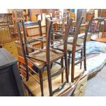 A harlequin set of four Edwardian walnut framed standard chairs with rattan seat panels and turned